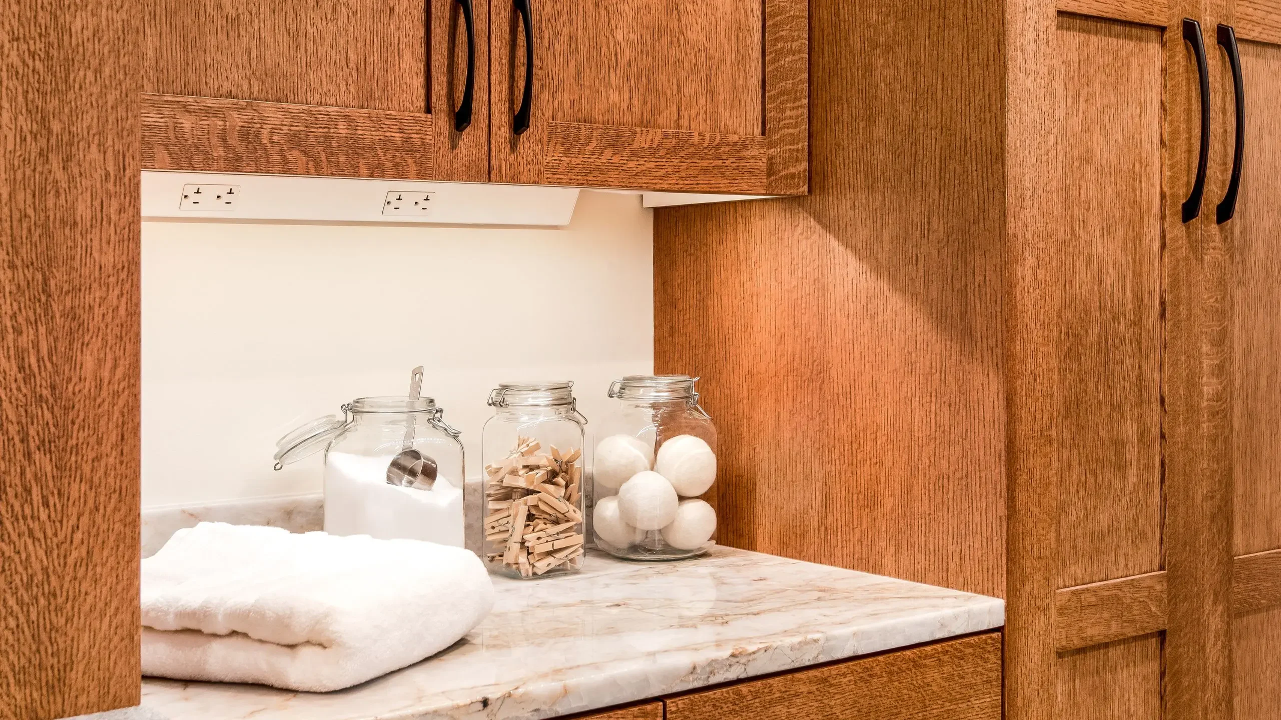 laundry room countertop with mason jars with detergent and clothespins