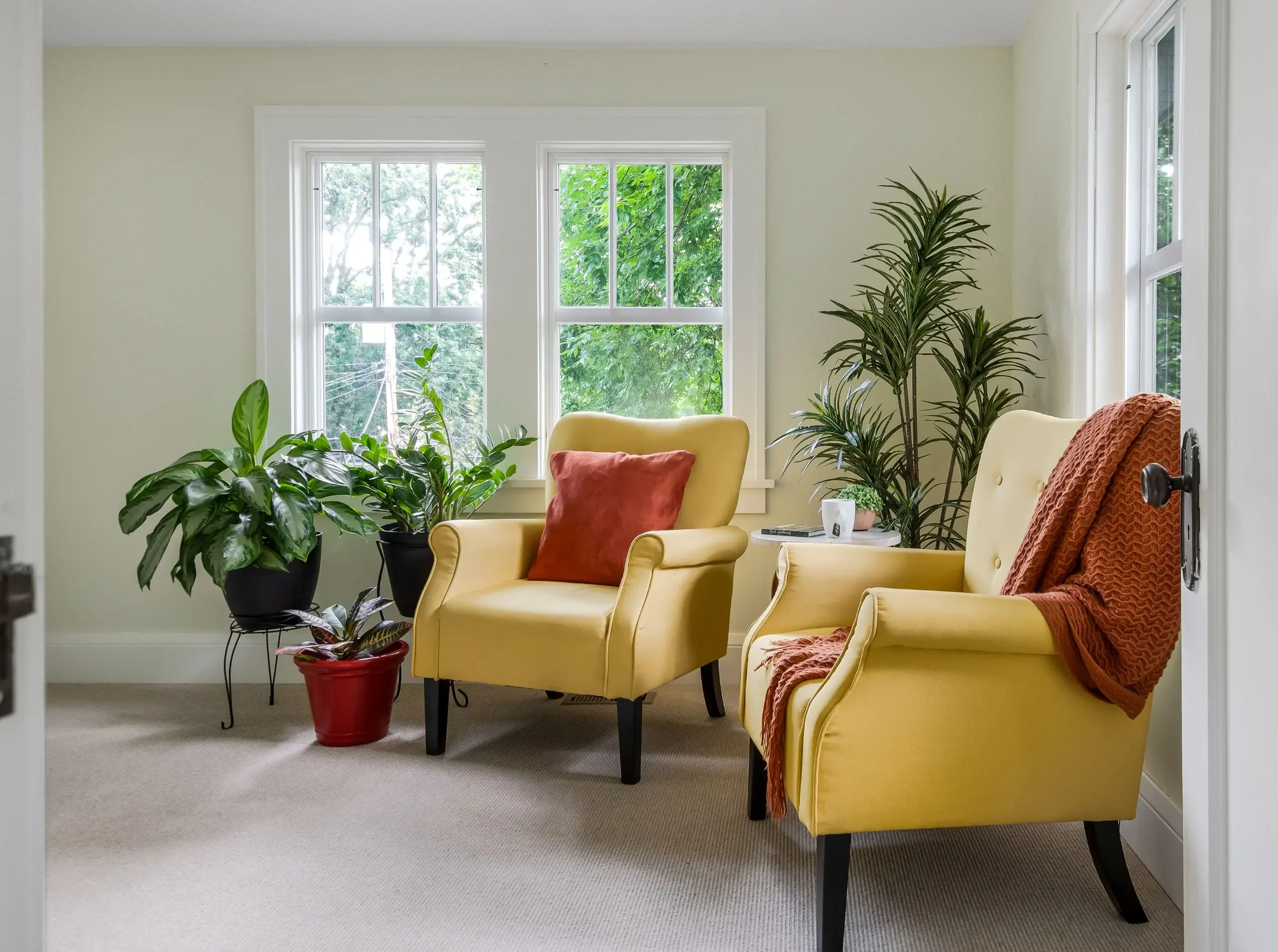 two yellow comfy chairs in a bonus space in an addition