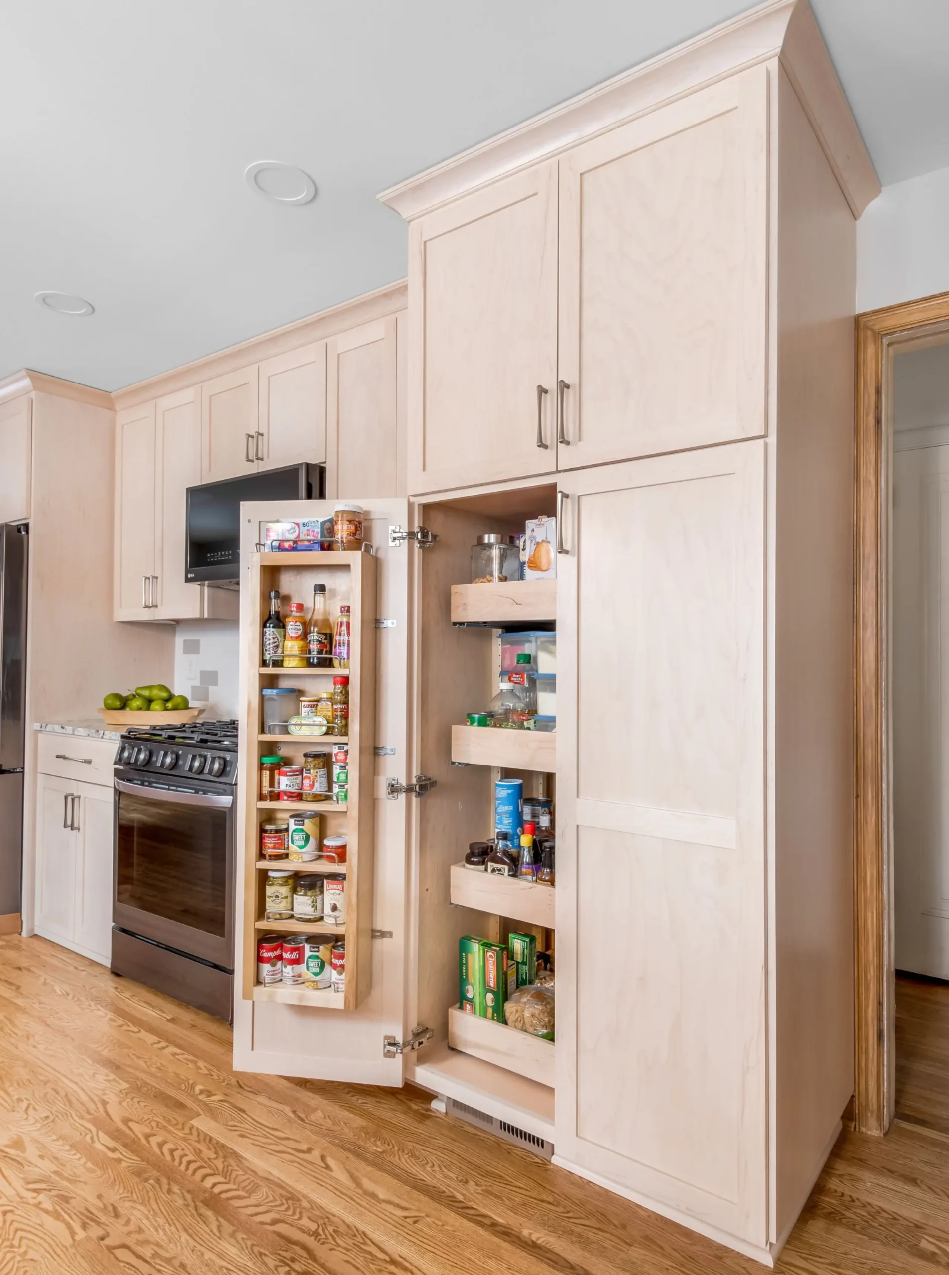 pantry with door open displaying pull-out shelving with food easy to grab 