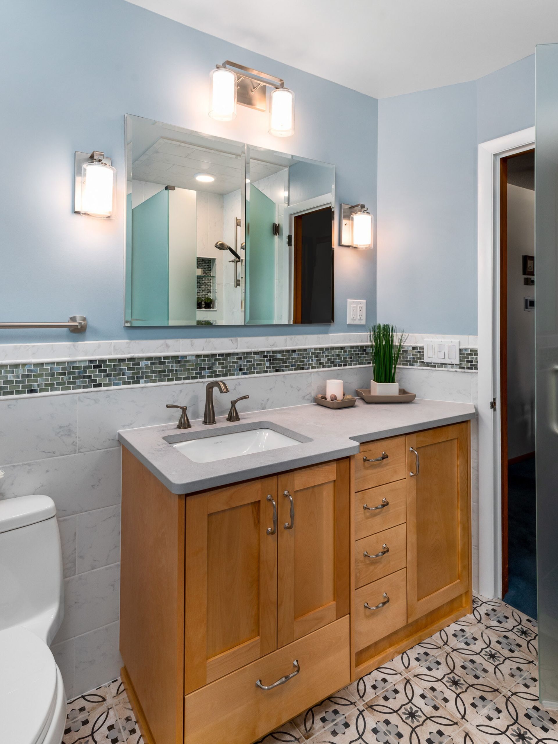 wood bathroom vanity with frameless mirror above
