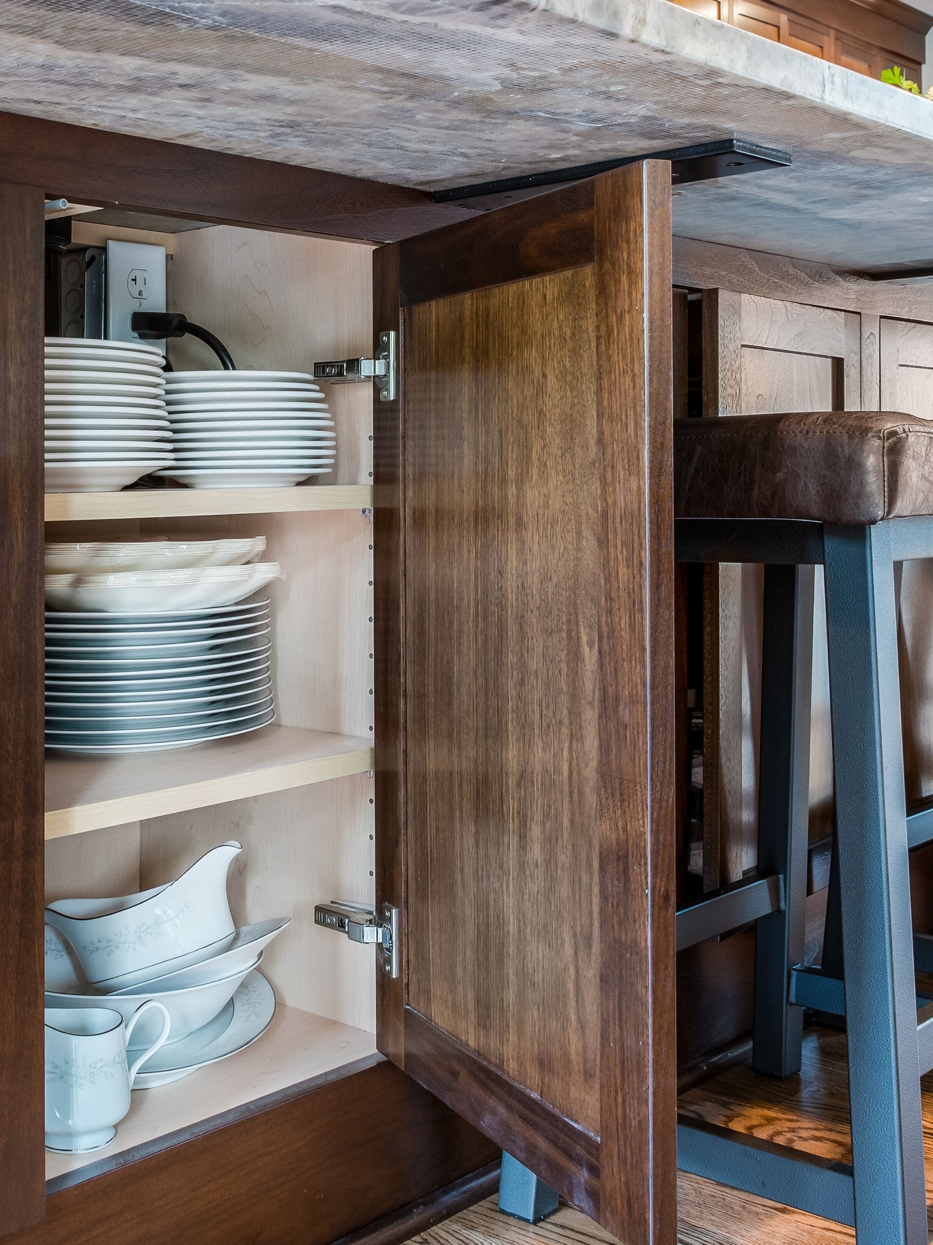 white dishes in a kitchen island cabinet
