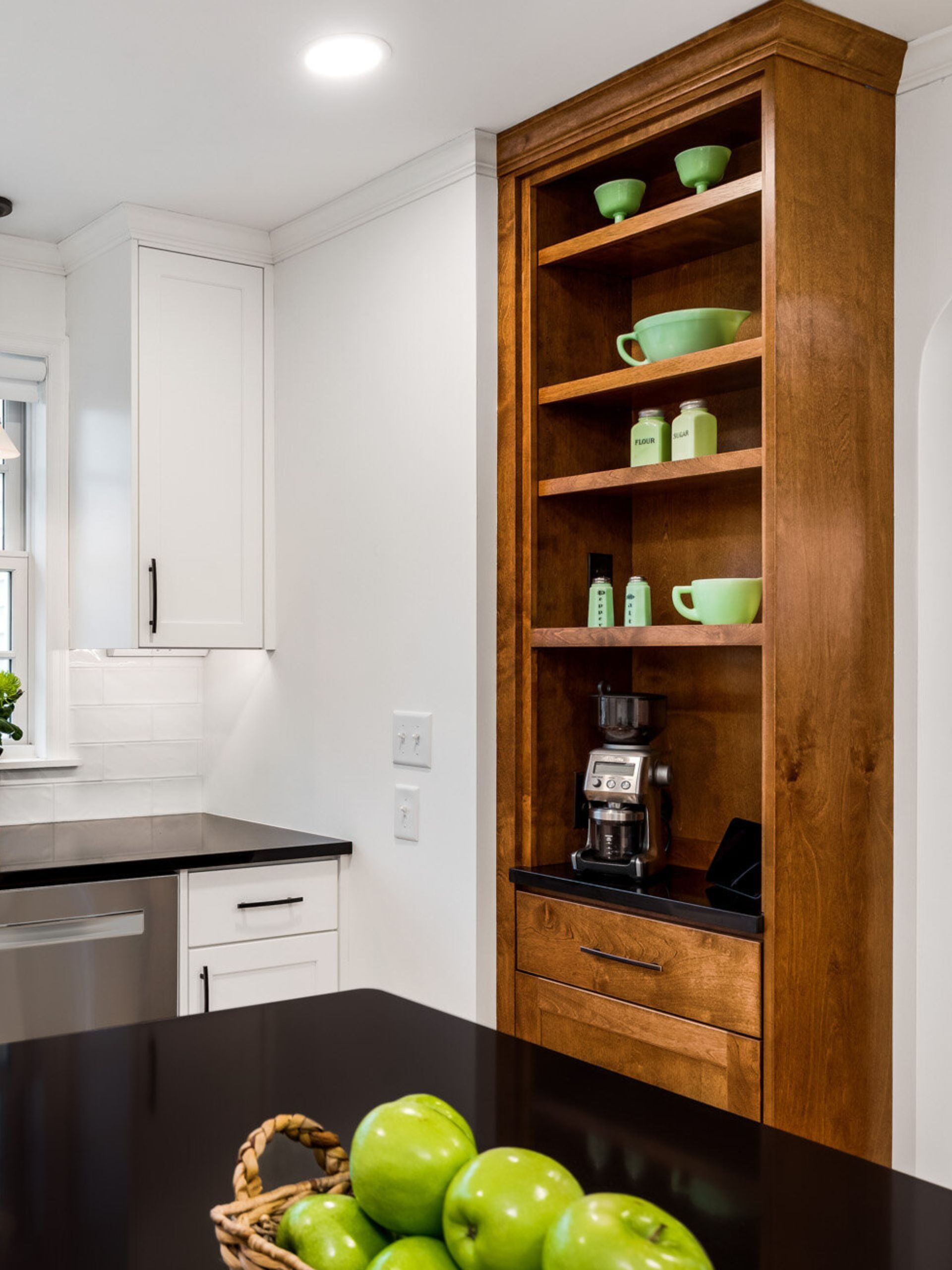 wood built with display shelves with green dishes and coffee bar and drawer below