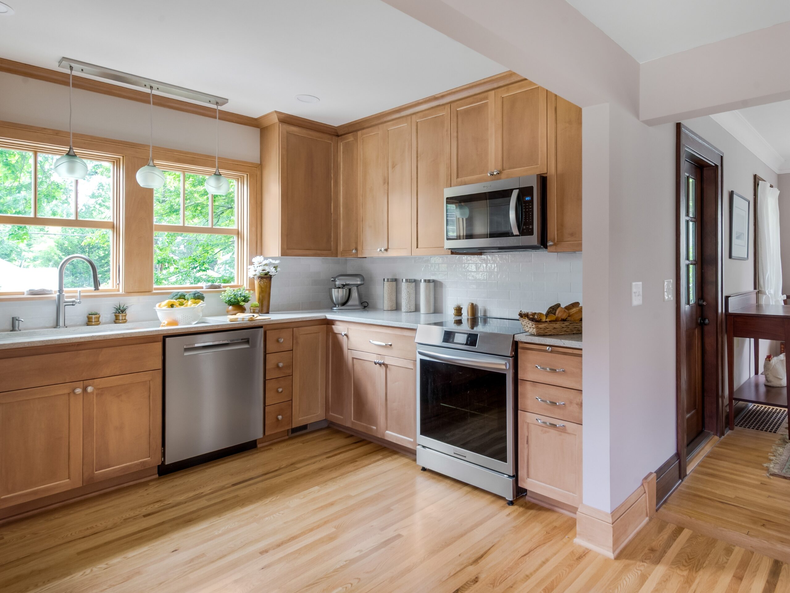 Updated kitchen with natural wood cabinetry in a Foursquare remodel