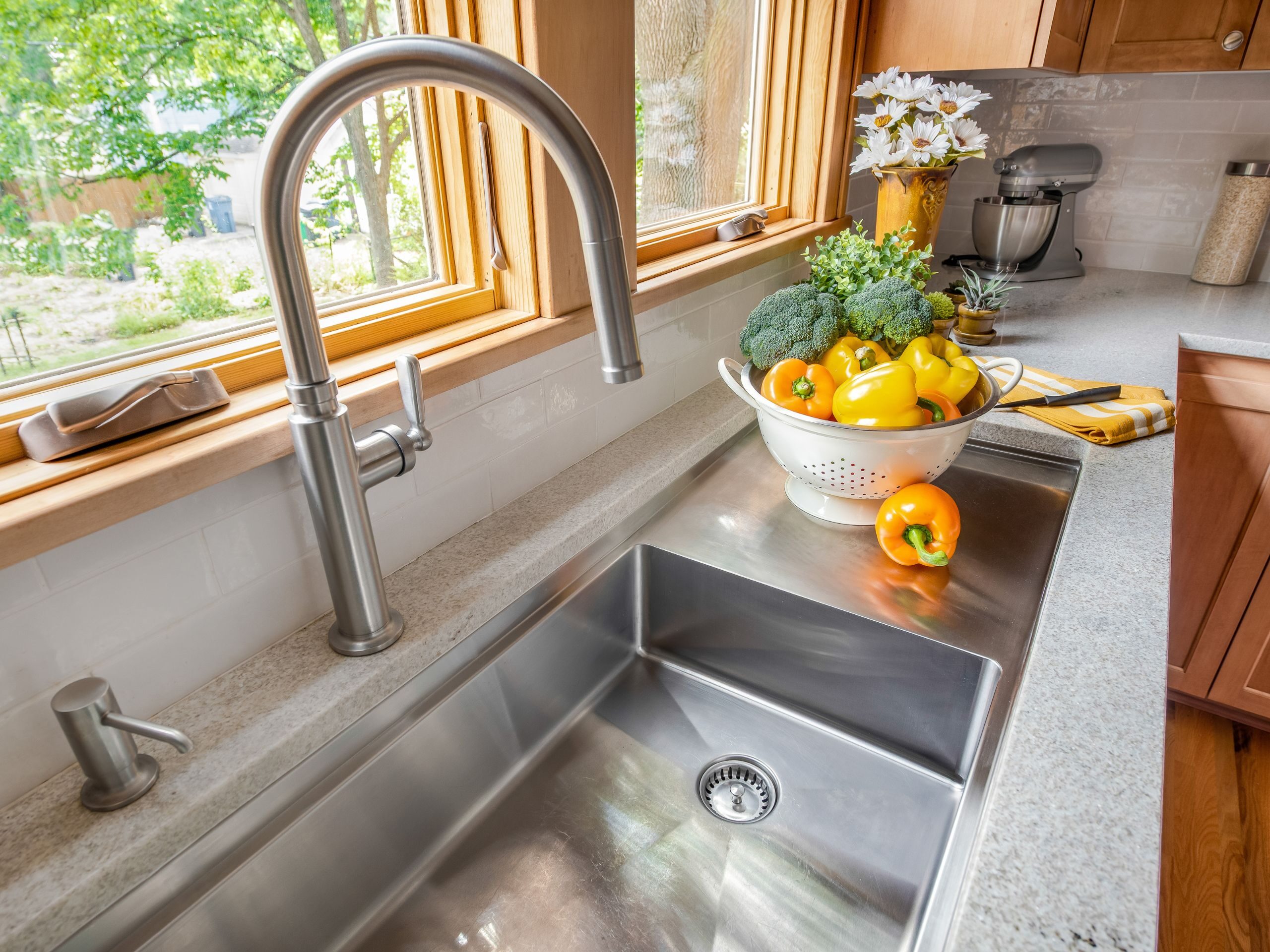 Swedish style sink with a colander of vegetables 